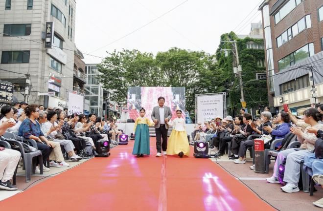 박강수 마포구청장이 마포구 지역 문화예술 행사 및 축제 지원사업으로 열린 한복 페스티벌에서 한복을 입은 어린이들과 함께 걷고 있다.